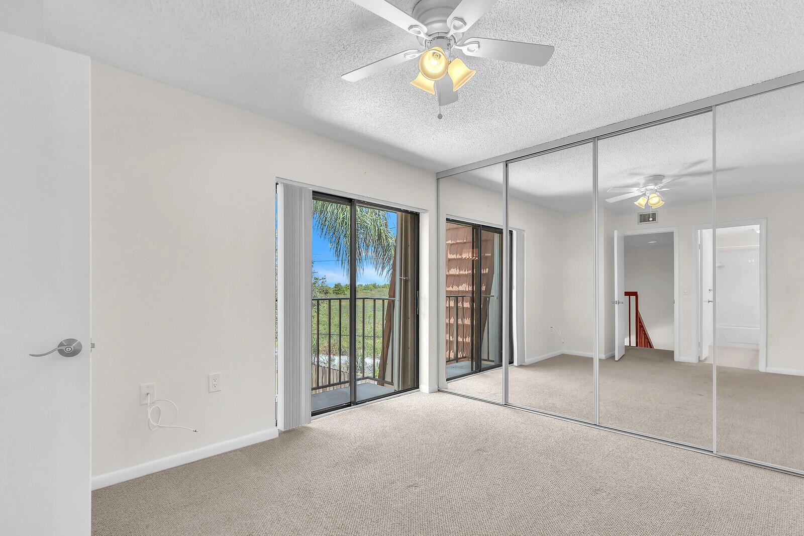 3026 30th Court Jupiter, FL 33477 - Photo 12 of 15 an empty room with closet and a chandelier fan