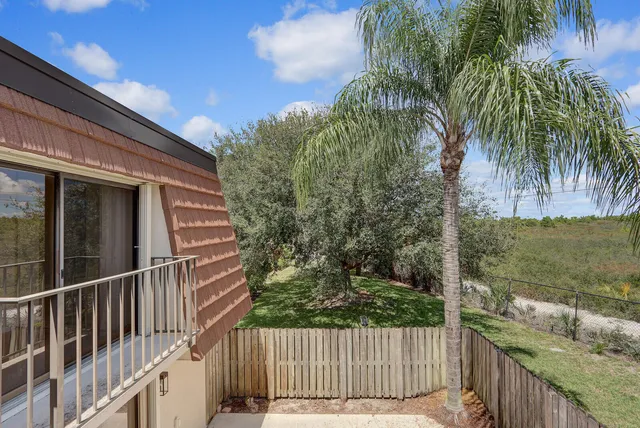 a view of a balcony with a yard