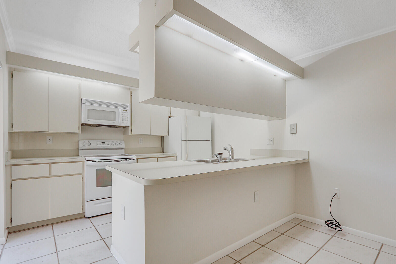 3026 30th Court Jupiter, FL 33477 - Photo 5 of 15 a kitchen with a sink stove and cabinets