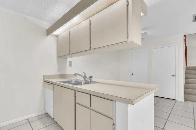 a bathroom with a sink and cabinets