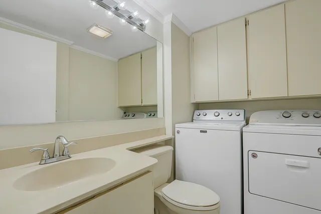 a view of bathroom with a sink a toilet and vanity