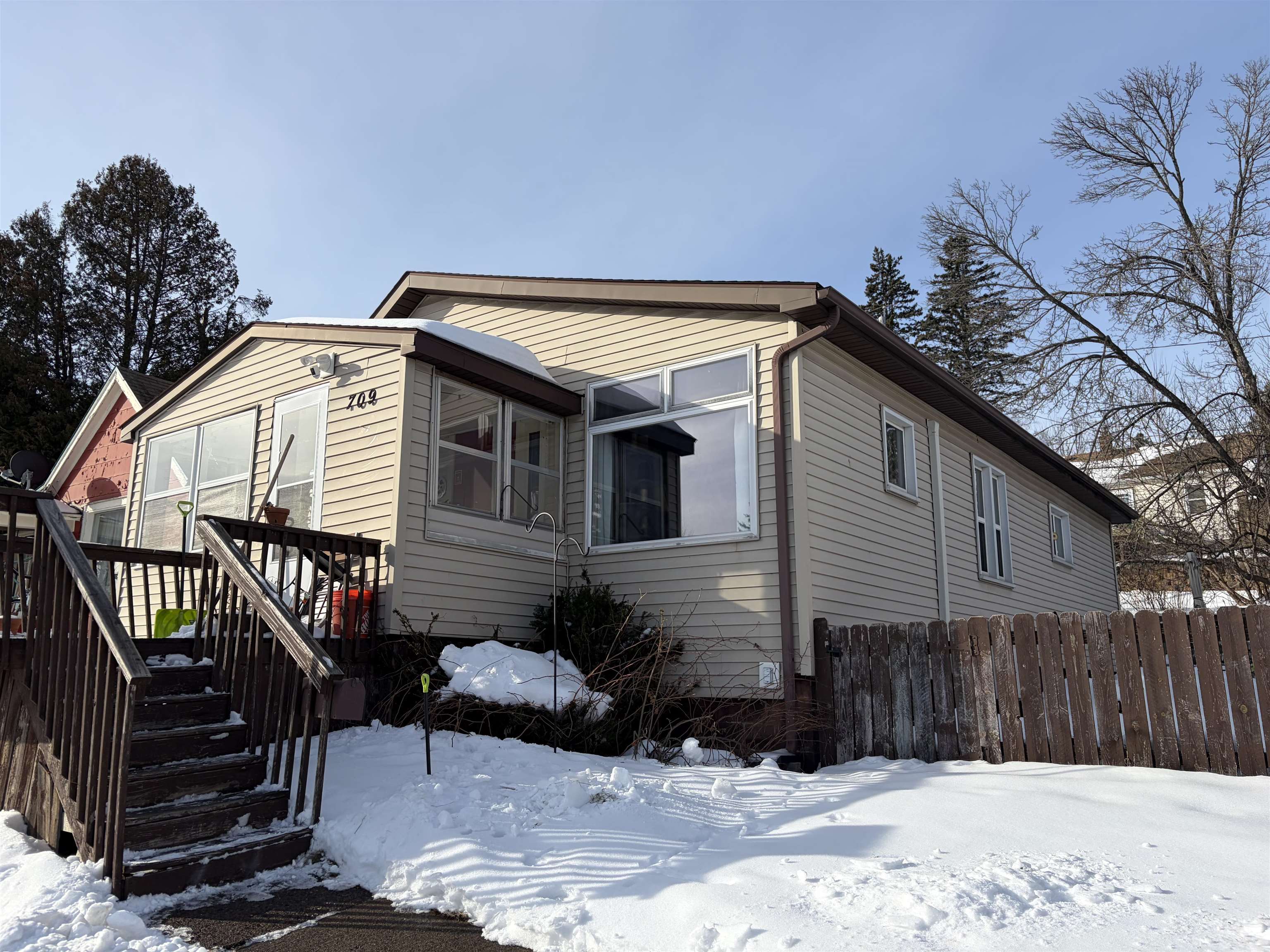 View of front of home with a wooden deck