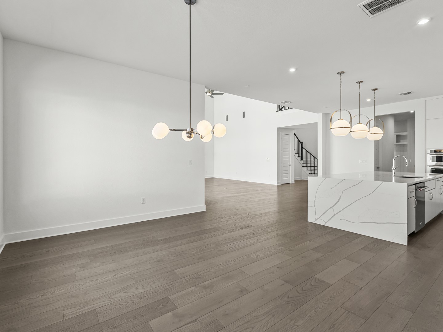 2508 Chiavari Way Leander, TX 78641 - Photo 5 of 24 Elegant wide plank wood flooring and contemporary lighting illuminate this bright open concept space.