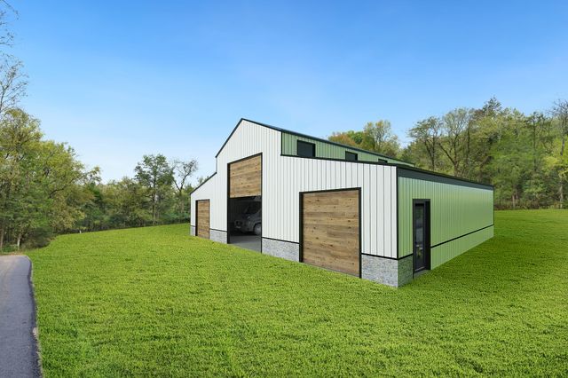 a front view of house with yard and trees in the background