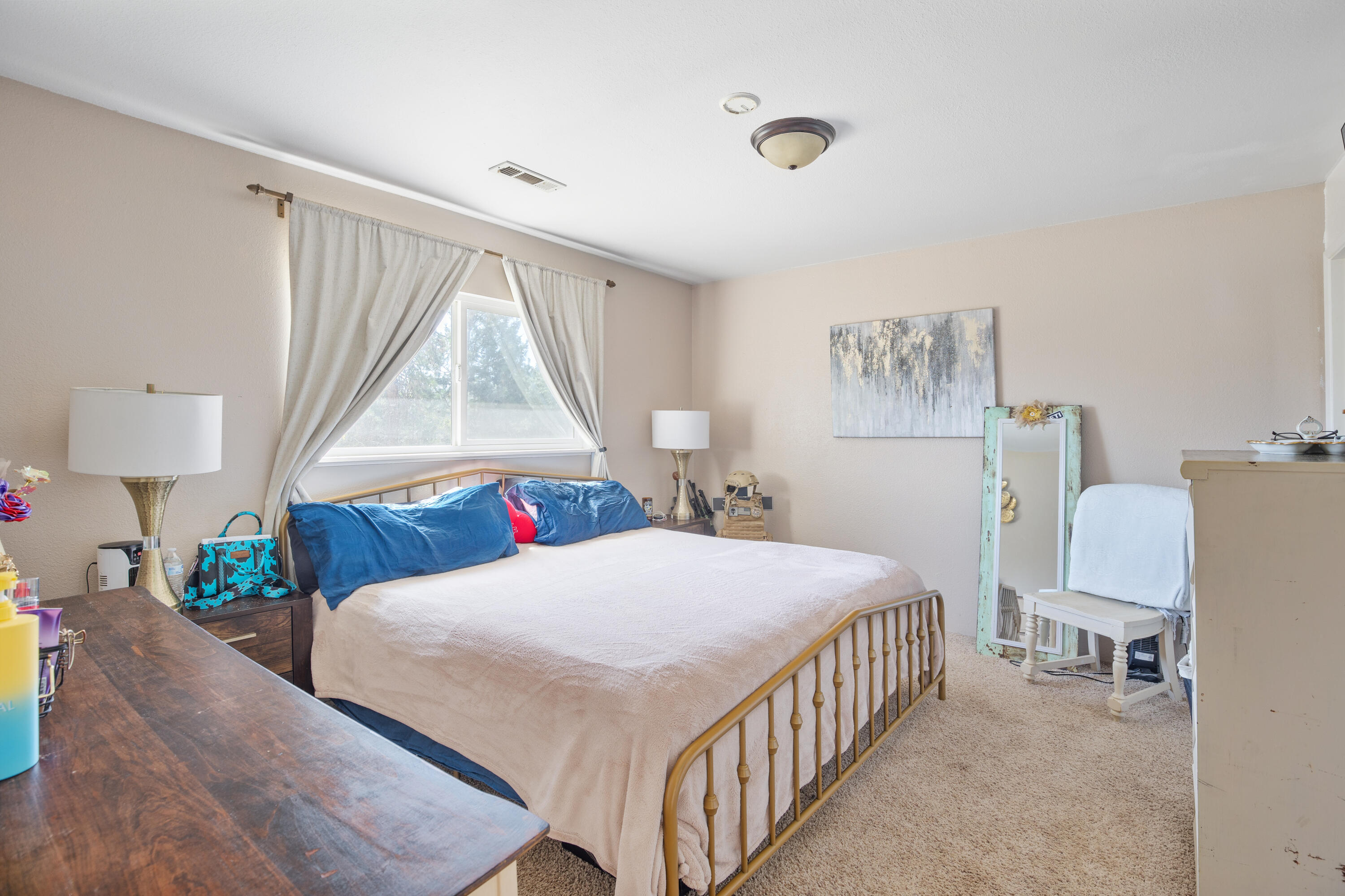 12748 Water Gap Road Williams, OR 97544 - Photo 12 of 35 a bedroom with a bed a couch and a window