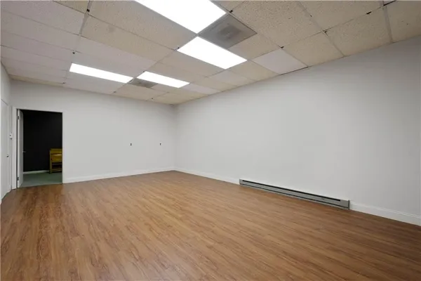 a view of an empty room with wooden floor