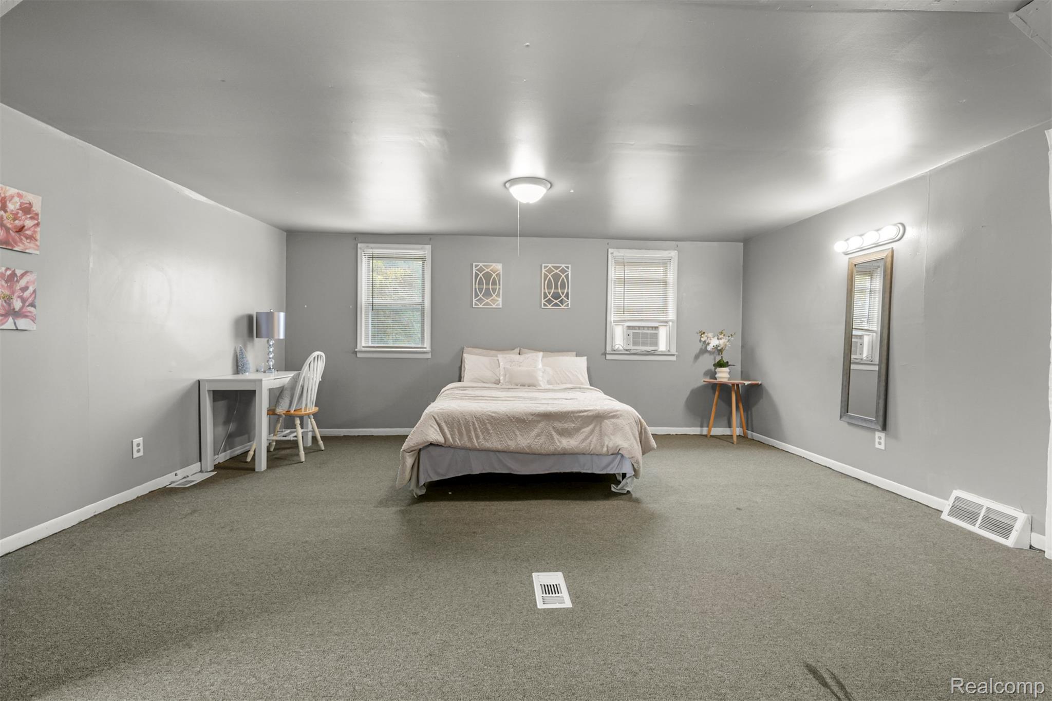 6780 Rutland Street Detroit, MI 48228 - Photo 27 of 35 Carpeted room with two windows, a ceiling-mounted light fixture, and wall-mounted lighting