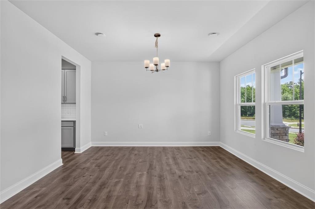 107 Ledgemont Way Acworth, GA 30101 - Photo 5 of 57 wooden floor in an empty room with a window