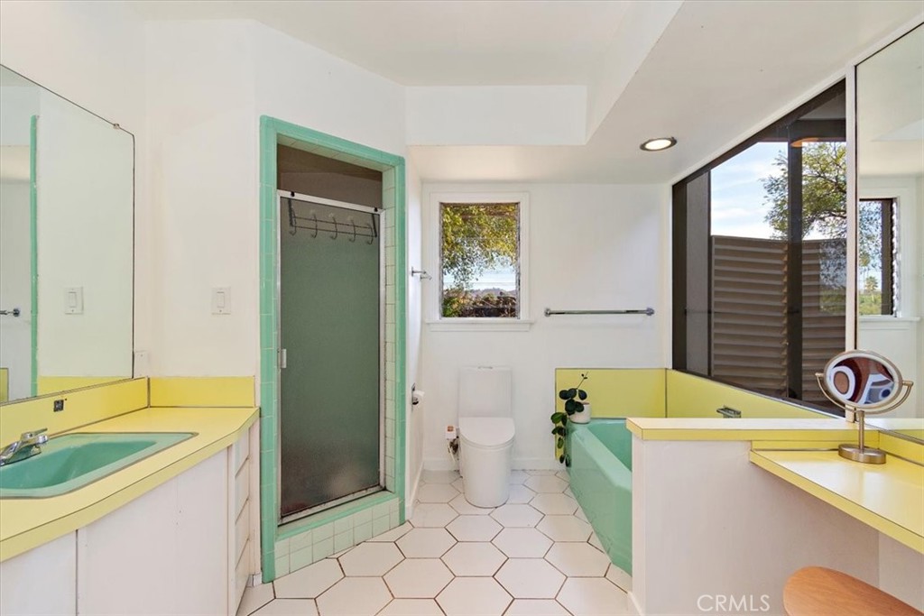 3052 Panorama Road Riverside, CA 92506 - Photo 30 of 53 a spacious bathroom with a granite countertop tub sink a mirror and a shower