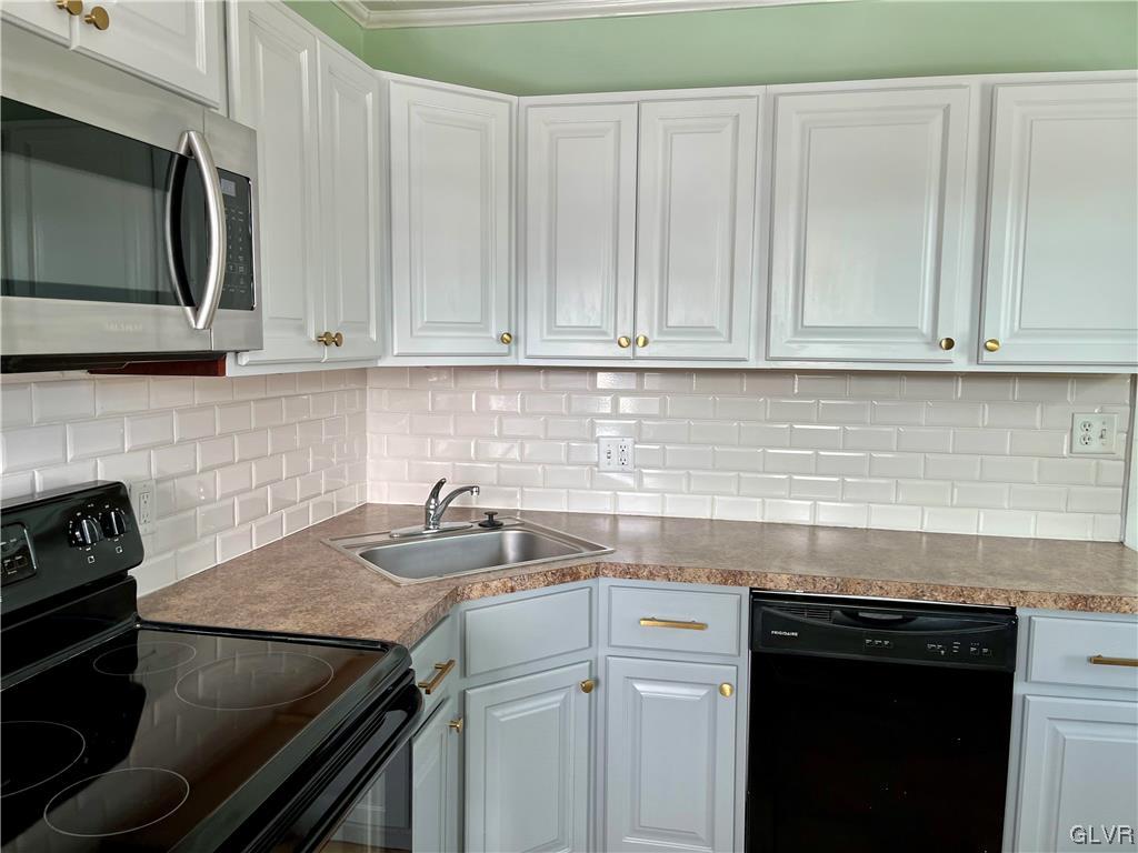 715 Spring Street Bethlehem, PA 18018 - Photo 7 of 28 a kitchen with a sink stove and microwave