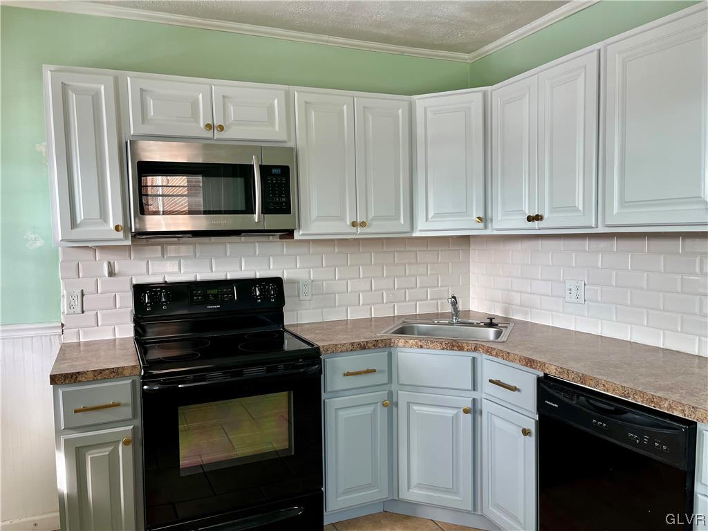 715 Spring Street Bethlehem, PA 18018 - Photo 8 of 28 a kitchen with cabinets stainless steel appliances and a sink stove