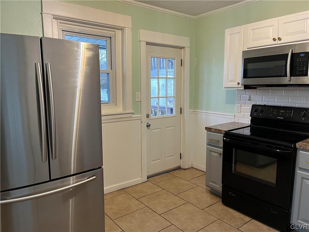 715 Spring Street Bethlehem, PA 18018 - Photo 9 of 28 a kitchen with stainless steel appliances granite countertop a refrigerator and a stove top oven