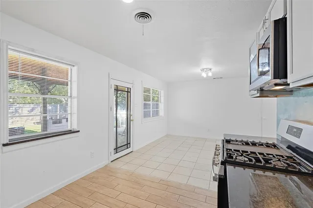 a kitchen with a stove and a window