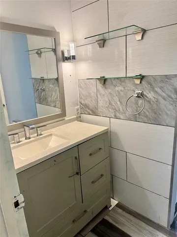 a bathroom with a sink and mirror