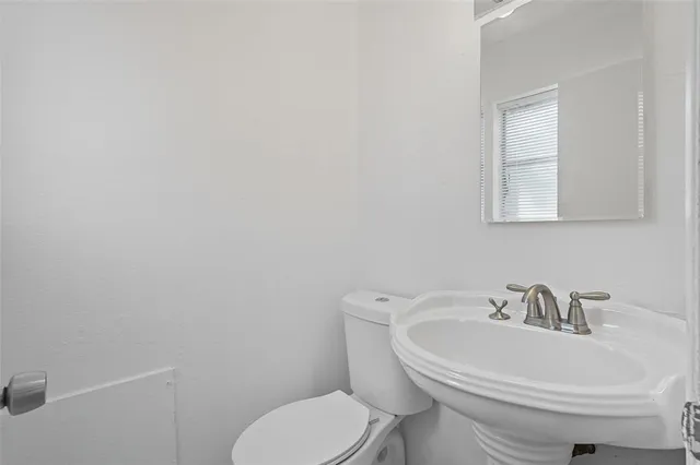 a white toilet sitting next to a white sink