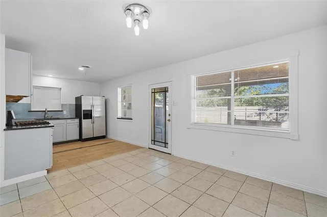 a view of a kitchen with microwave and refrigerator
