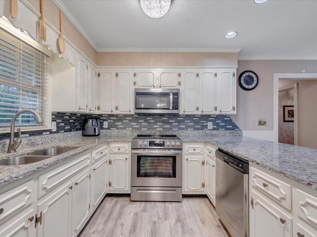 525 Mulberry Road Ridgeway, VA 24148 - Photo 13 of 55 a kitchen with granite countertop white cabinets and a stove