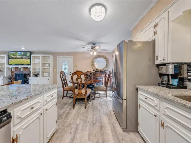 a kitchen with granite countertop a sink and a window
