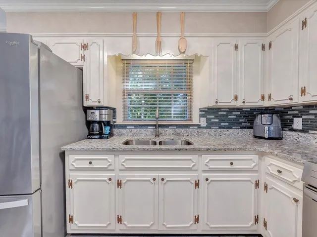 a kitchen with stainless steel appliances granite countertop a sink and cabinets