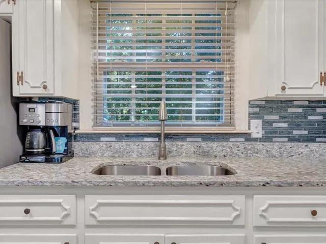 a kitchen with appliances cabinets and a sink