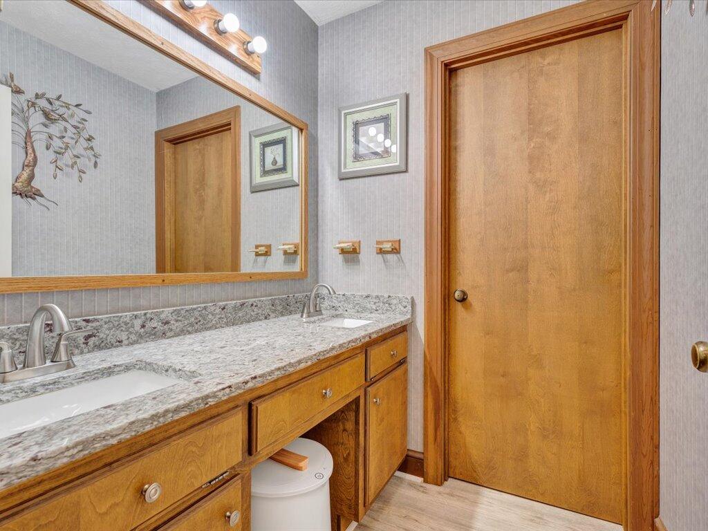 525 Mulberry Road Ridgeway, VA 24148 - Photo 19 of 55 a bathroom with a granite countertop sink and a mirror