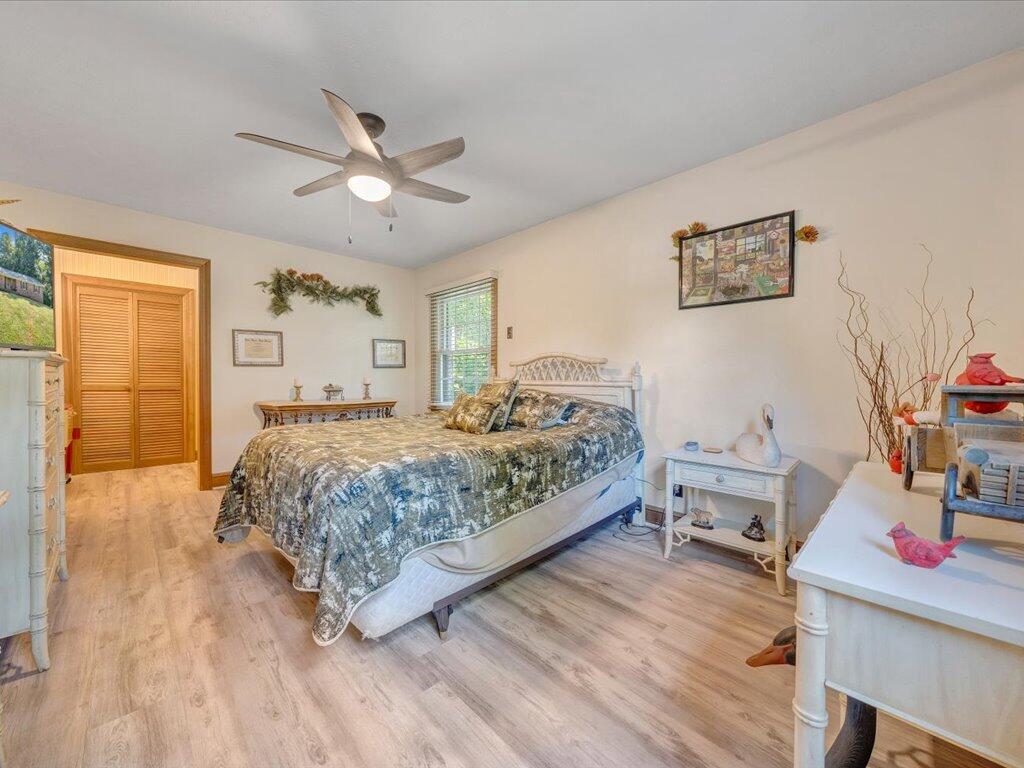 525 Mulberry Road Ridgeway, VA 24148 - Photo 24 of 55 a bedroom with a bed and a chandelier