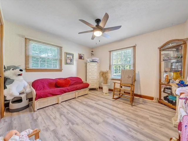 a living room with furniture and a gym machine