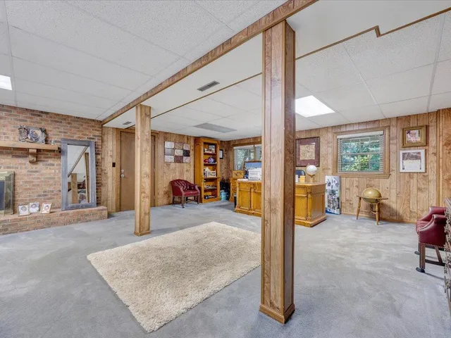 a living room with furniture gym equipment and a large window