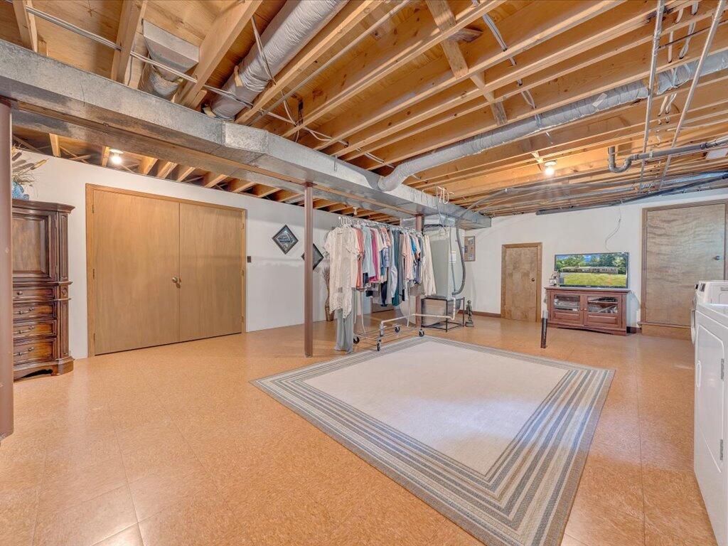 525 Mulberry Road Ridgeway, VA 24148 - Photo 39 of 55 a room with lots of wooden furniture and a chandelier