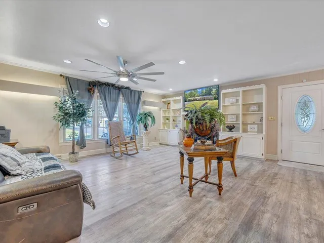 a living room with furniture and a wooden floor
