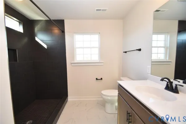 a bathroom with a sink toilet and vanity