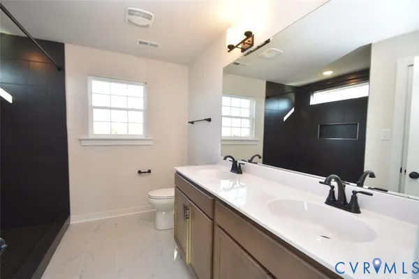 a bathroom with 2 sink and a mirror
