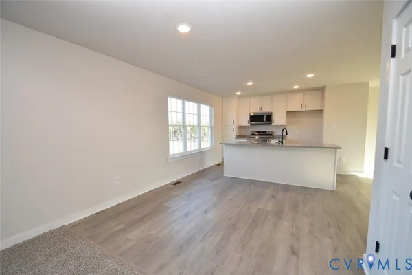 a view of a kitchen with a sink and a window