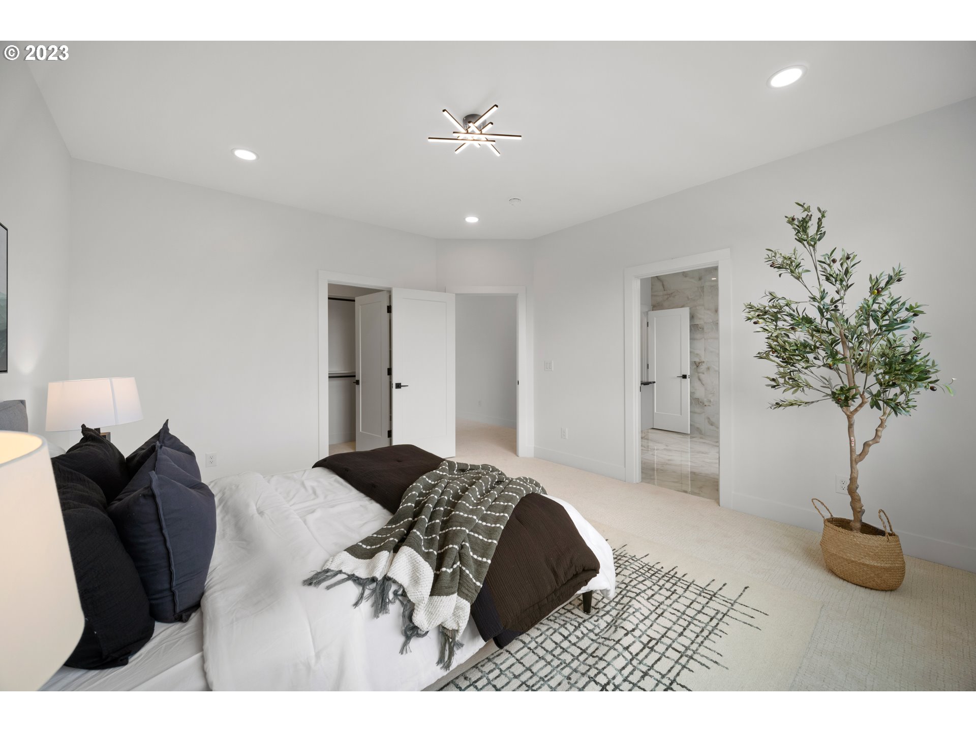 2121 South Wind River Way Ridgefield, WA 98642 - Photo 23 of 40 a bedroom with a bed and a potted plant