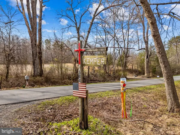 a view of a livingroom with wooden floor and furniture