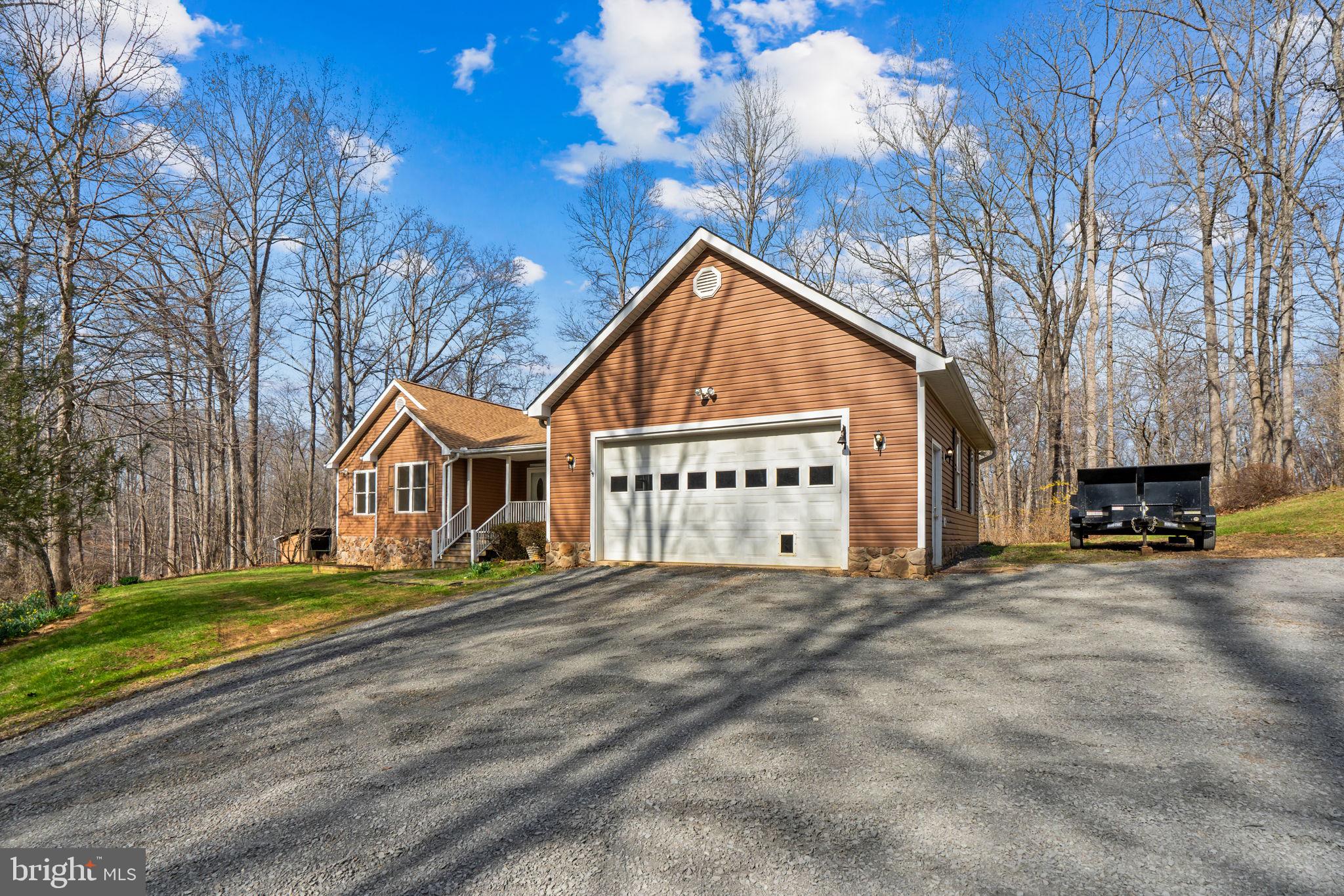 584 South Poes Road Amissville, VA 20106 - Photo 16 of 82 a view of a house with a big yard and large trees