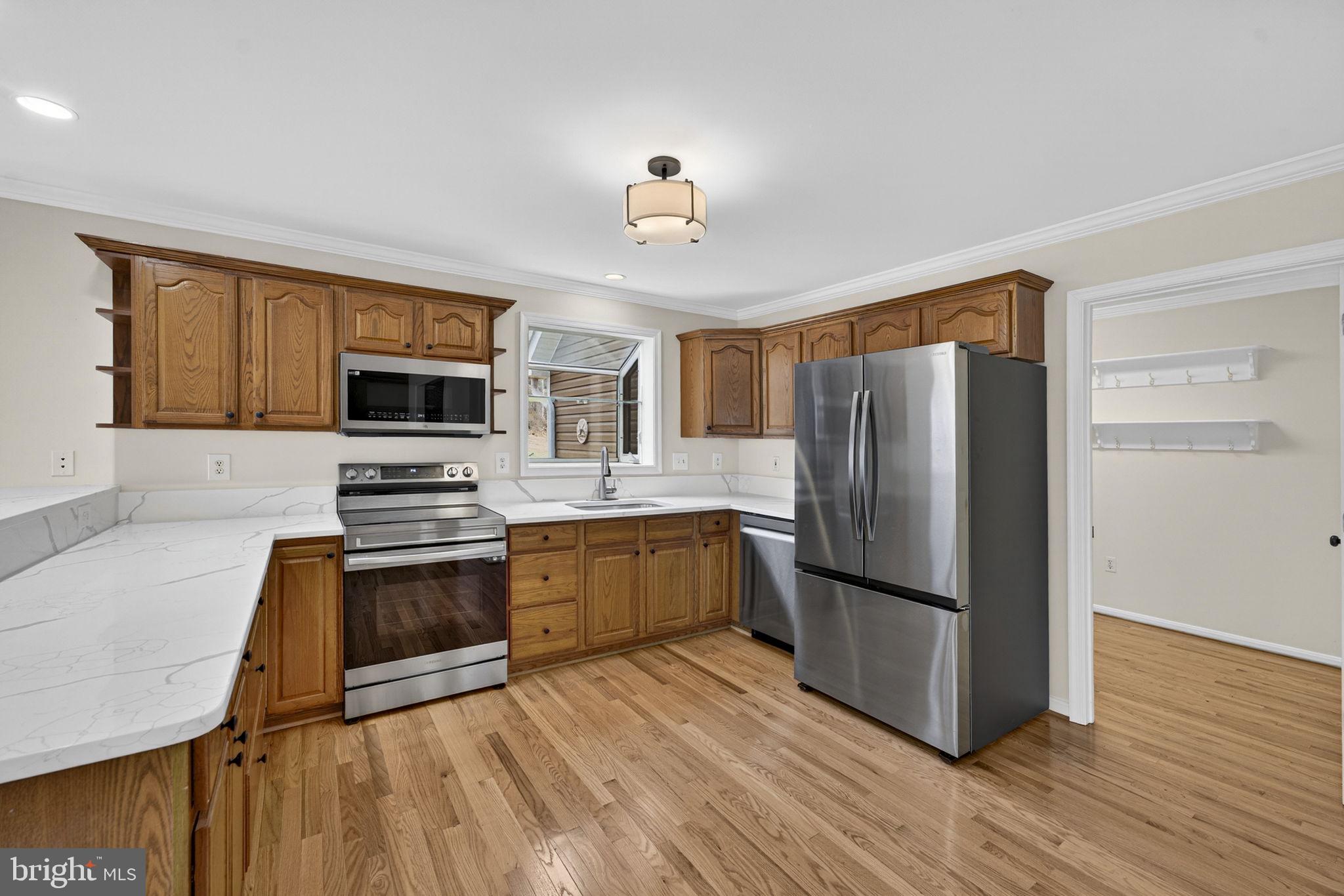 584 South Poes Road Amissville, VA 20106 - Photo 36 of 82 a kitchen with granite countertop a refrigerator stove and microwave