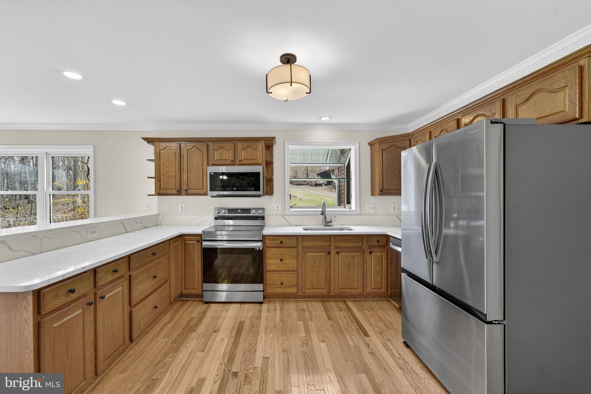 584 South Poes Road Amissville, VA 20106 - Photo 37 of 82 a kitchen with stainless steel appliances granite countertop a refrigerator and a stove top oven
