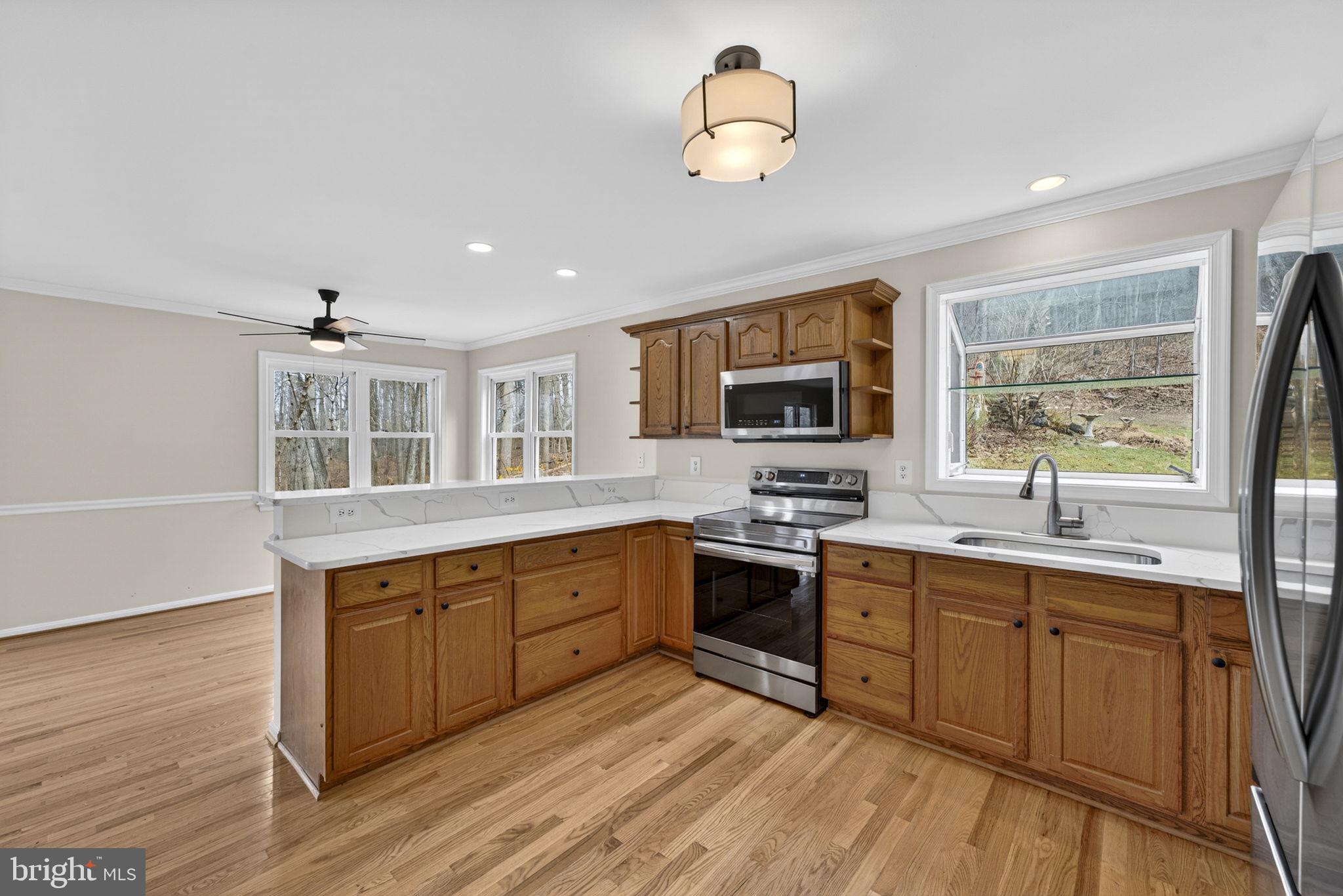 584 South Poes Road Amissville, VA 20106 - Photo 38 of 82 a large kitchen with stainless steel appliances granite countertop a stove and a sink