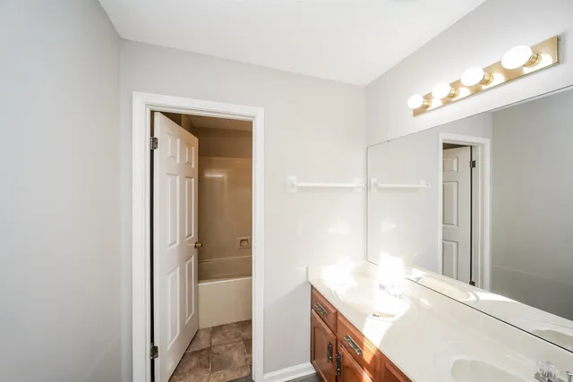 a bathroom with a sink a vanity and a mirror