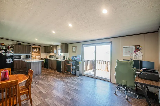a living room with furniture a wooden floor and a window