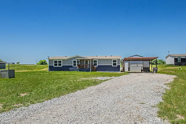 a yellow and red house with a big yard