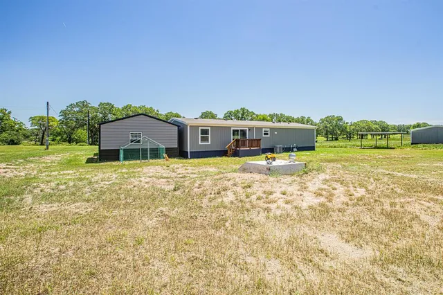a view of a house with a big yard