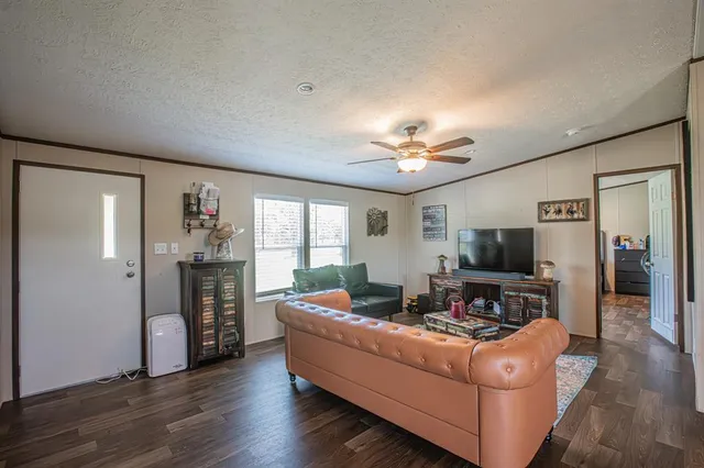 a living room with furniture and a flat screen tv