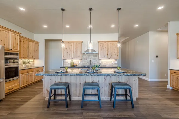 a bathroom with a granite countertop toilet a sink and a mirror