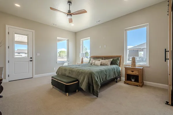 an empty room with closet and a chandelier fan