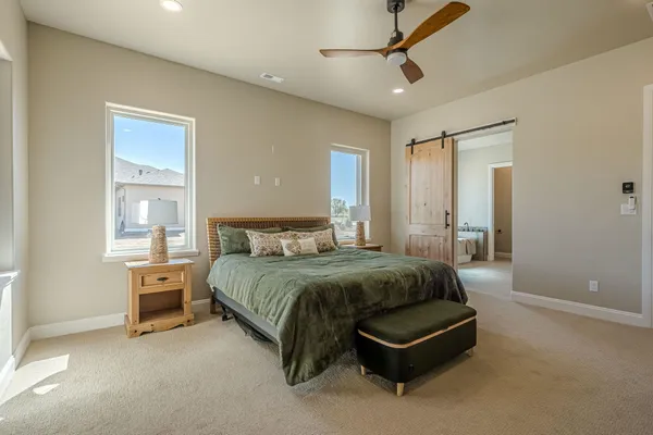 an empty room with closet and a chandelier fan