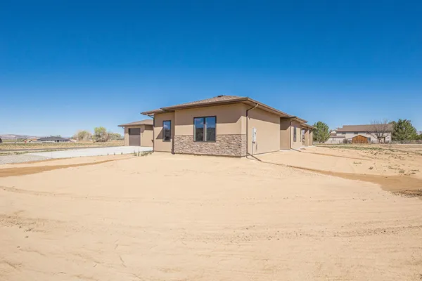 a large kitchen with stainless steel appliances lots of counter space and windows
