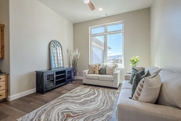 a kitchen with stainless steel appliances granite countertop wooden floor window and cabinets