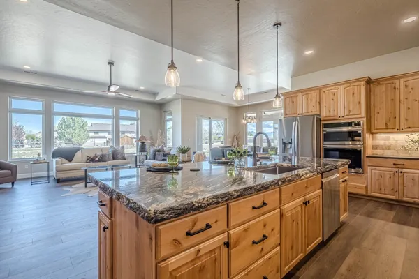 a living room with furniture and kitchen view